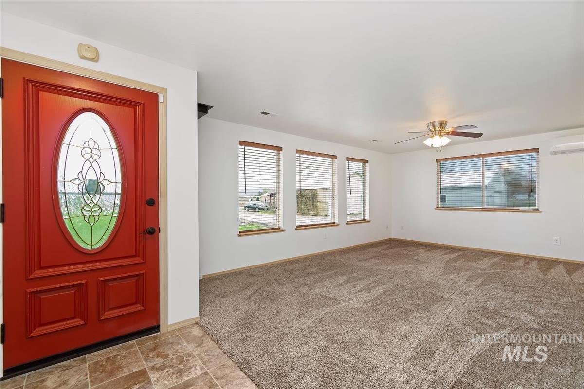 1051 Haas Road Weiser, ID 83672 - Photo 4 of 44 Foyer entrance featuring light colored carpet and a ceiling fan