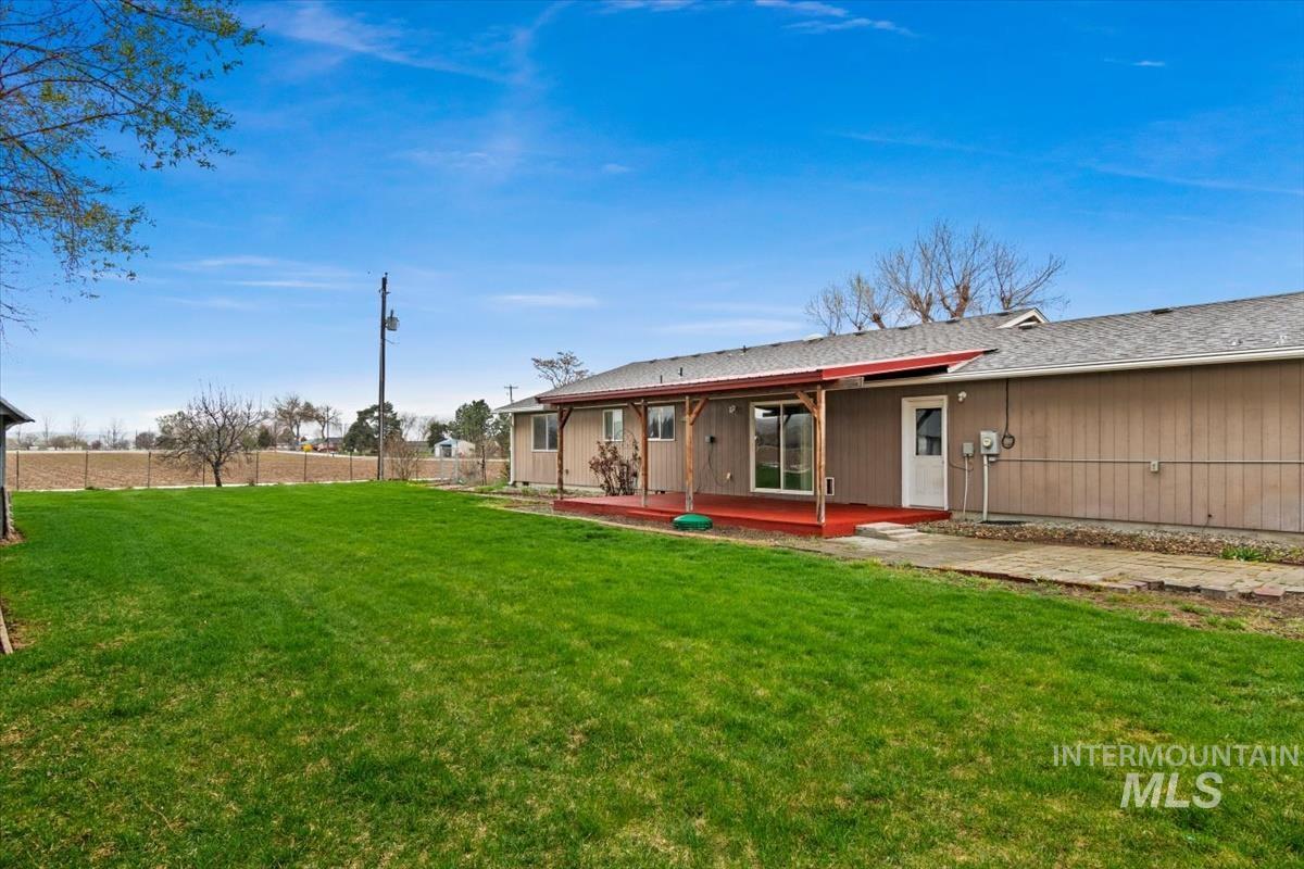 1051 Haas Road Weiser, ID 83672 - Photo 38 of 44 Back of house with a patio and a shingled roof