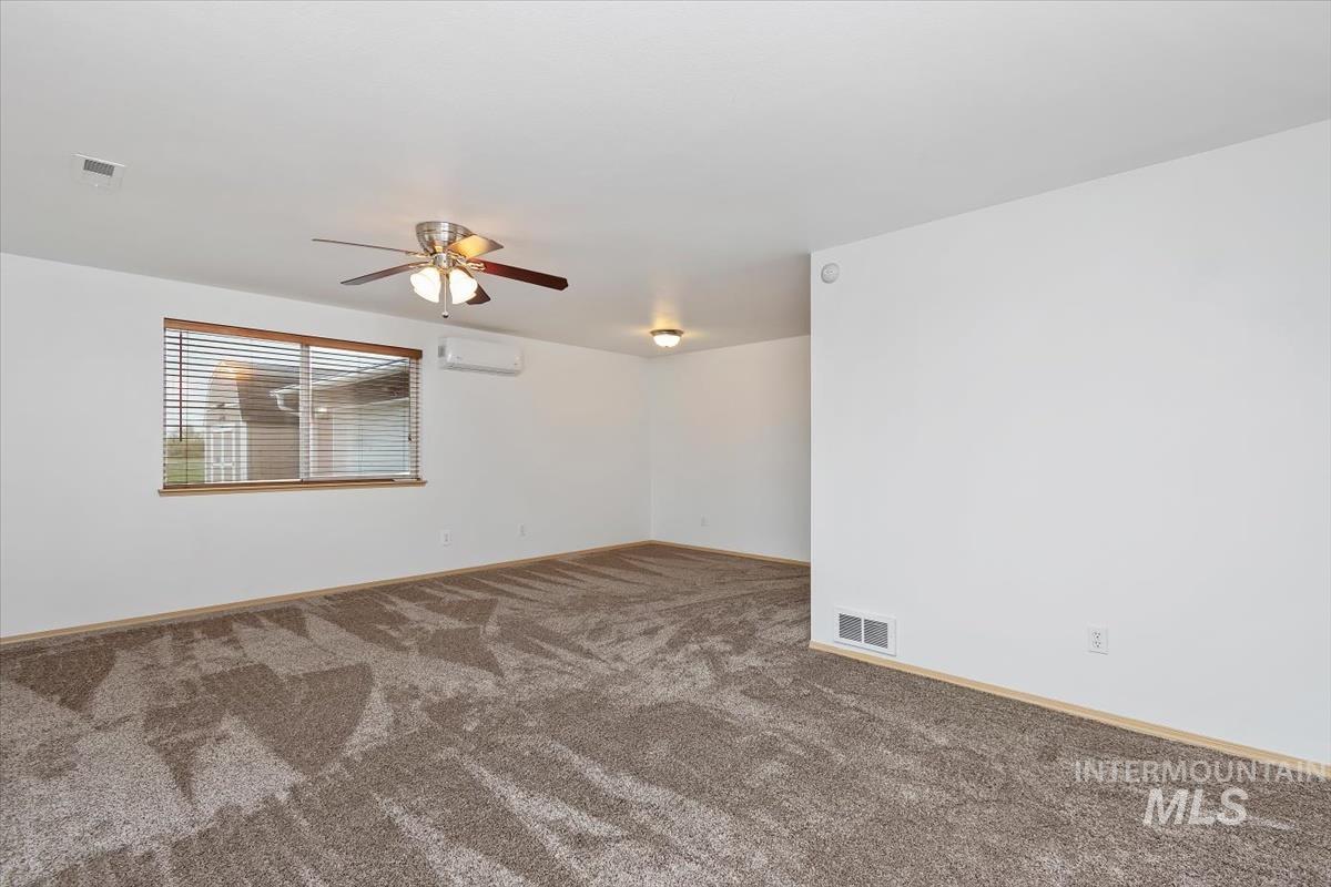 1051 Haas Road Weiser, ID 83672 - Photo 5 of 44 Spare room with dark colored carpet and a ceiling fan