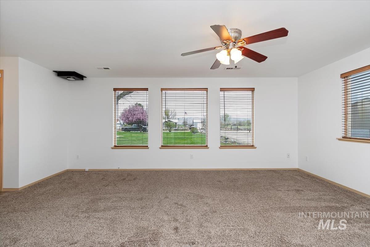 1051 Haas Road Weiser, ID 83672 - Photo 6 of 44 Unfurnished room with ceiling fan, carpet, and healthy amount of natural light