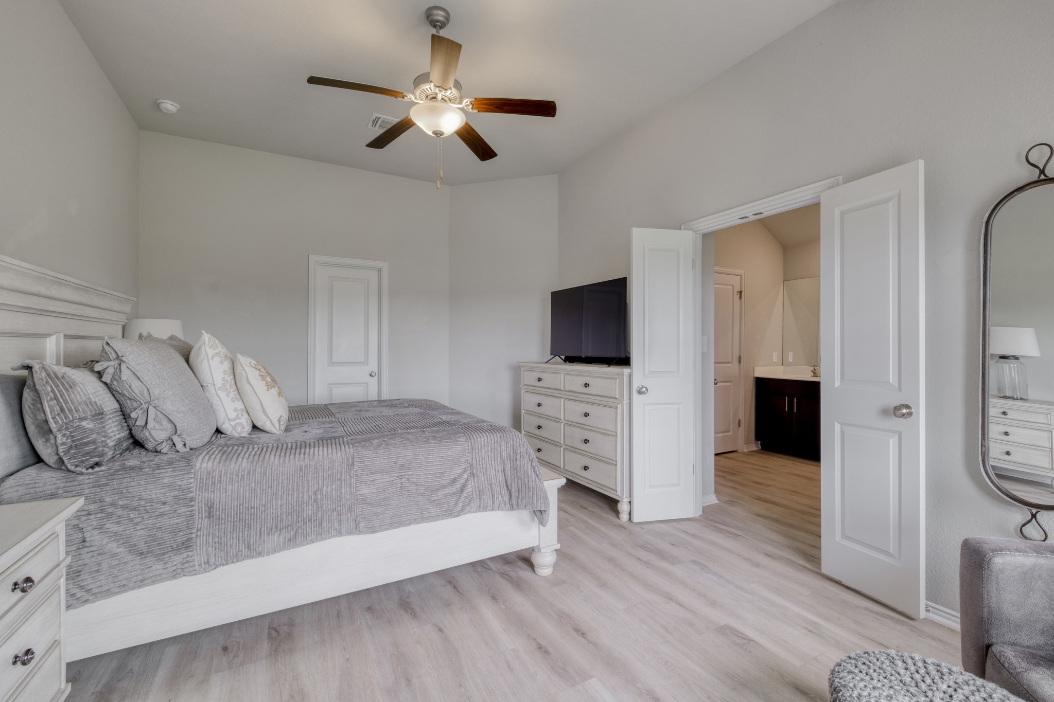 1000 Bright Star Cove Georgetown, TX 78628 - Photo 17 of 40 a bedroom with a bed and a flat tv screen on dresser