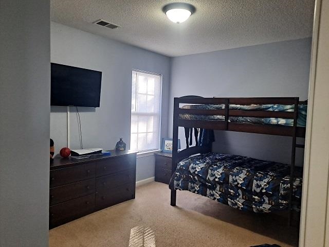 4356 Cedar Hills Road Memphis, TN 38135 - Photo 12 of 18 a bedroom with a bed and a flat screen tv
