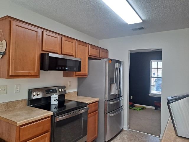 4356 Cedar Hills Road Memphis, TN 38135 - Photo 5 of 18 a kitchen with stainless steel appliances granite countertop a refrigerator stove and microwave