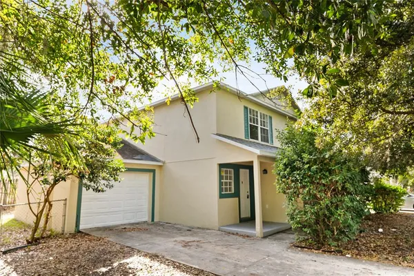 a house that has a tree in front of it