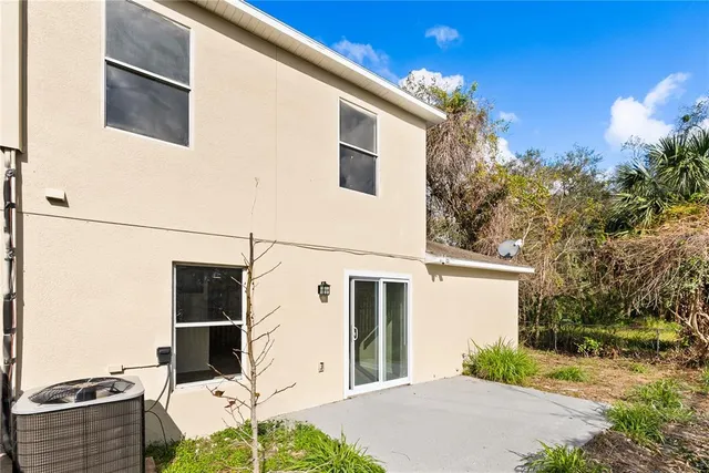 a backyard of a house with table and chairs