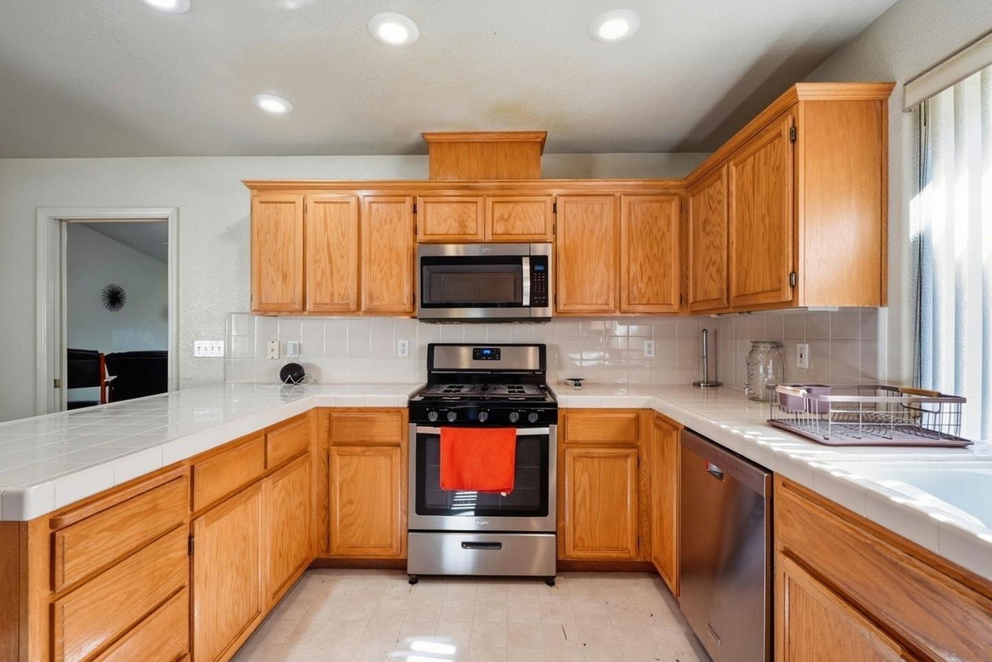 3882 Pintail Court Merced, CA 95340 - Photo 7 of 21 a kitchen with stainless steel appliances granite countertop a stove a sink and a microwave