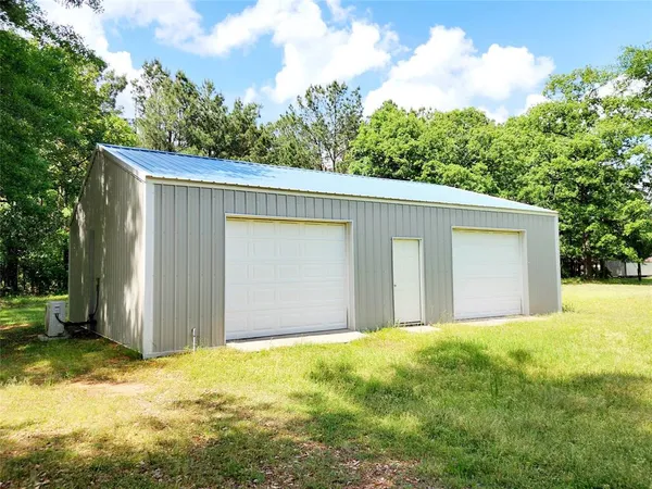 a view of a house with a yard and garage