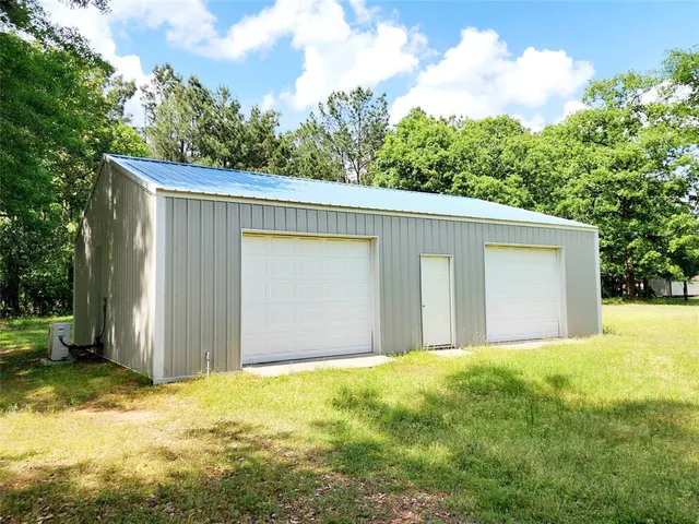 a view of a house with a yard and garage