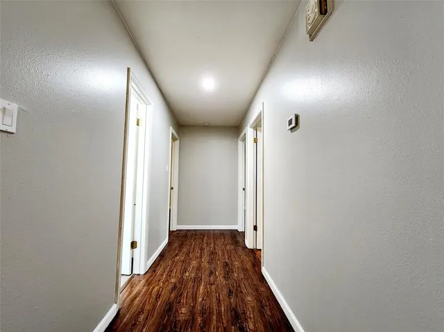 a view of hallway with wooden floor