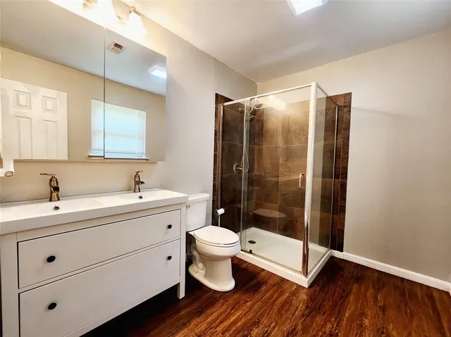a bathroom with a toilet sink and a shower