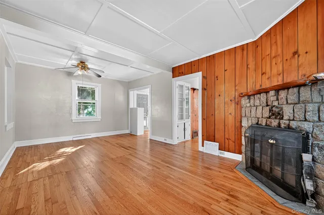 a view of an empty room and wooden floor