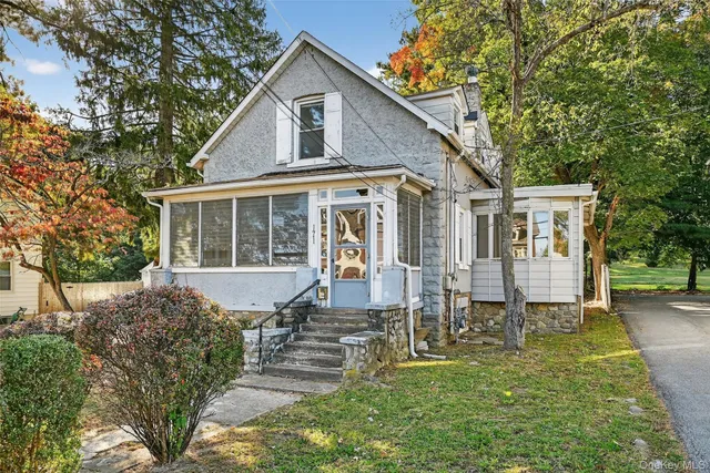 a front view of a house with a yard table and chairs