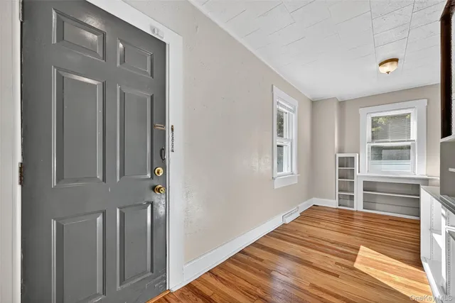 a view of wooden floor and windows in a room