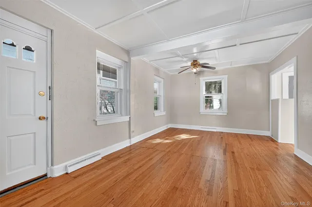 wooden floor in an empty room with a window