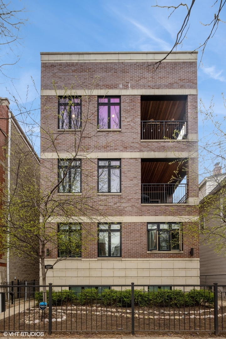 1833 West Addison Street, Unit 1S Chicago, IL 60613 - Photo 1 of 21 a front view of a building with glass windows