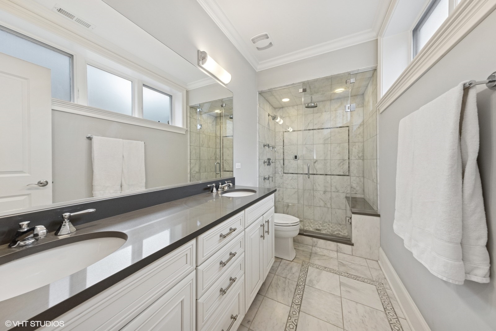 1833 West Addison Street, Unit 1S Chicago, IL 60613 - Photo 14 of 21 a spacious bathroom with a double vanity sink toilet mirror and double
