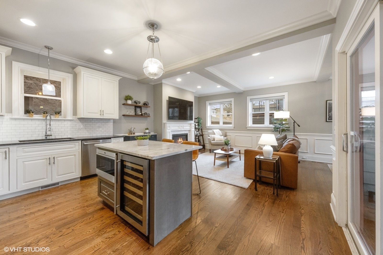 1833 West Addison Street, Unit 1S Chicago, IL 60613 - Photo 5 of 21 a kitchen with granite countertop a stove top oven a sink dishwasher a dining table and chairs with wooden floor