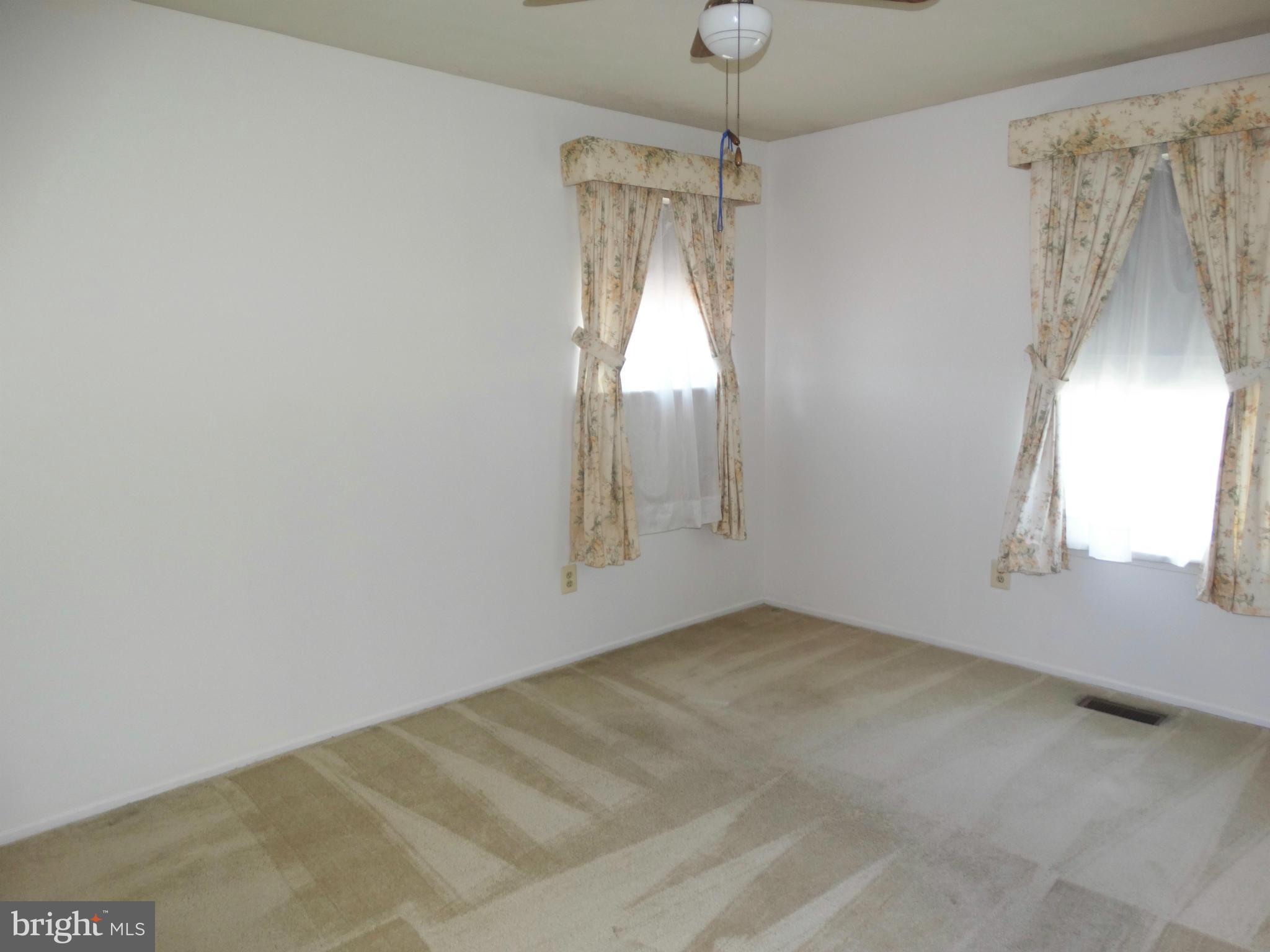 8204 Grainfield Road Severn, MD 21144 - Photo 11 of 30 an empty room with windows and entrance