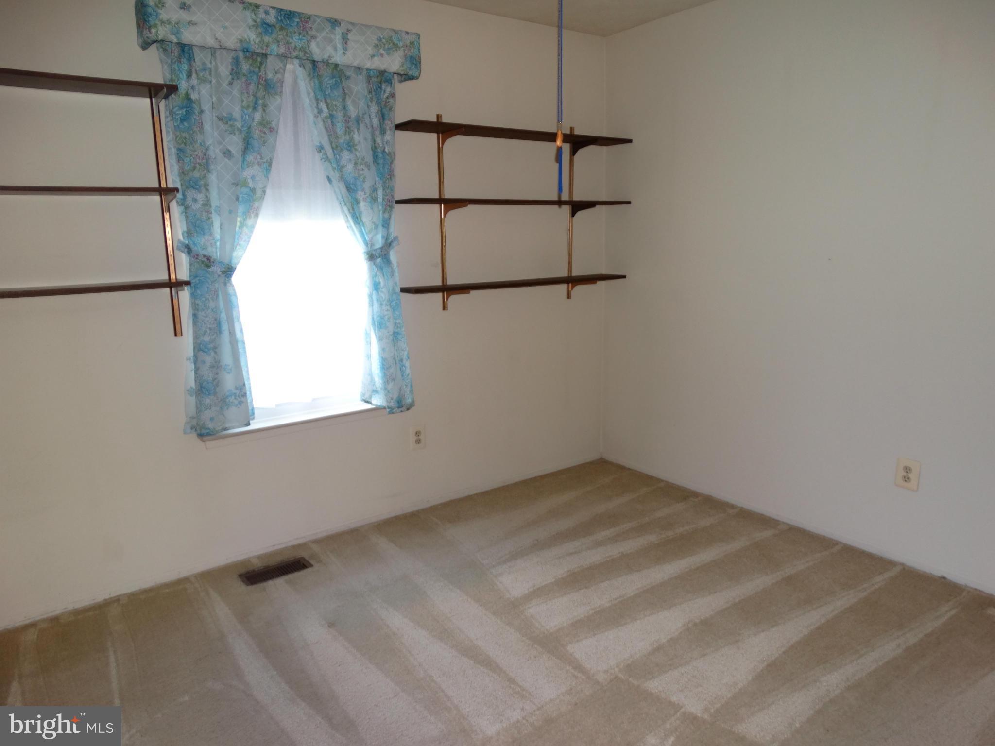 8204 Grainfield Road Severn, MD 21144 - Photo 12 of 30 a view of a room with rack on the wall and a window