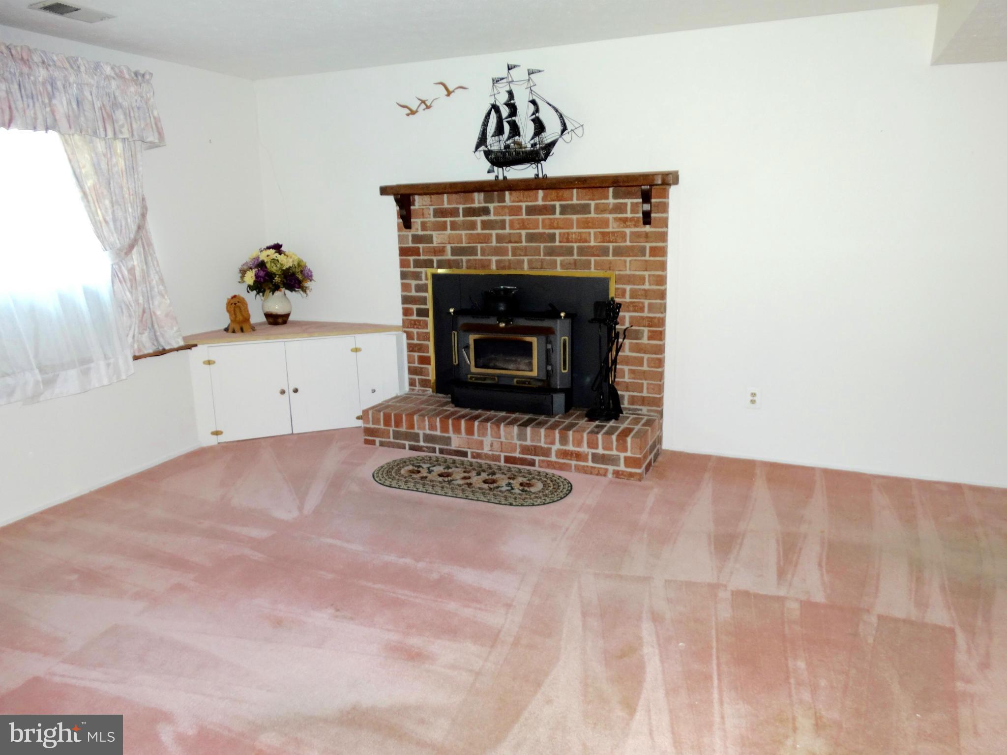 8204 Grainfield Road Severn, MD 21144 - Photo 15 of 30 a living room with furniture and a fireplace