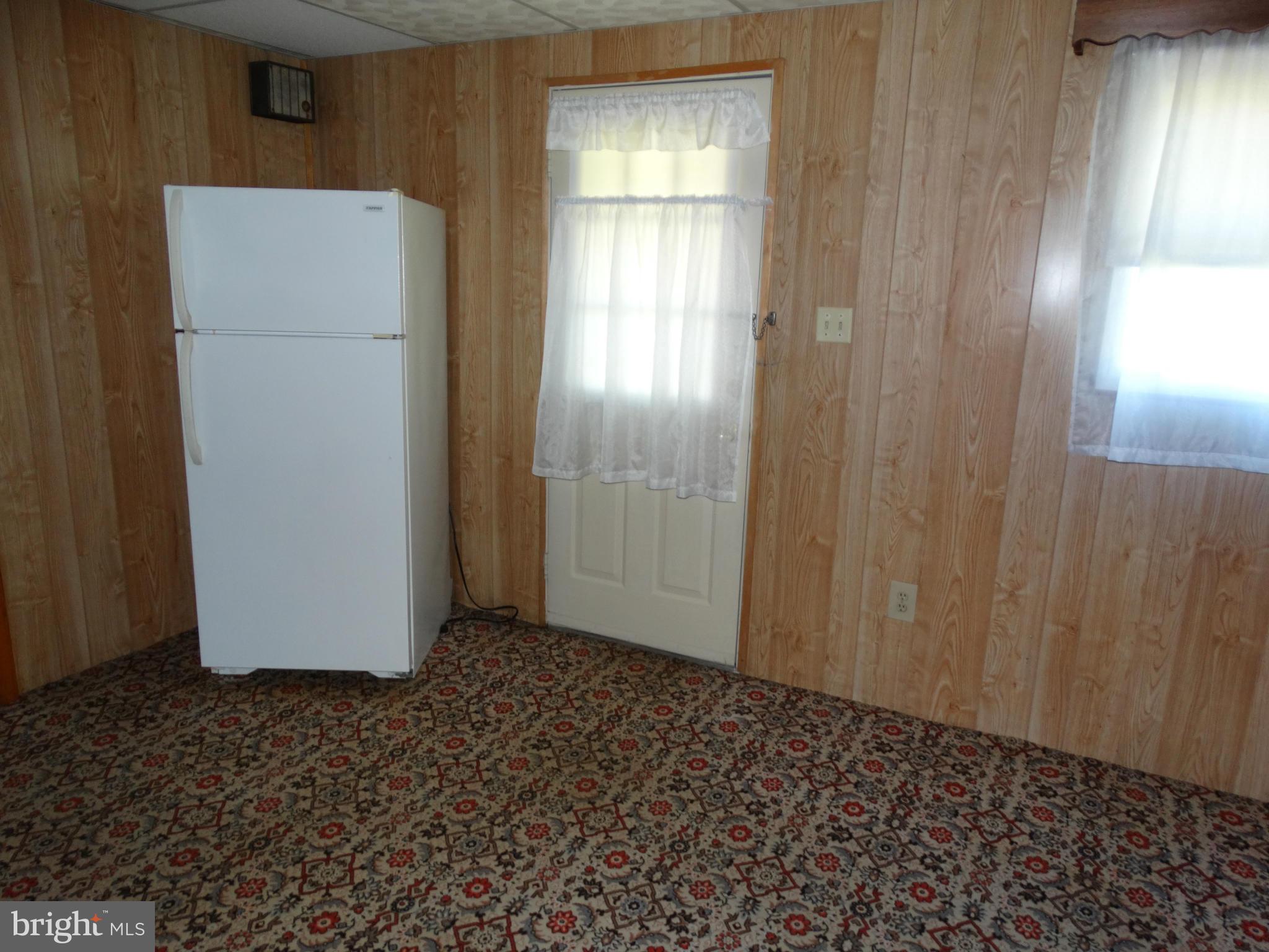 8204 Grainfield Road Severn, MD 21144 - Photo 20 of 30 a view of a refrigerator in kitchen and window