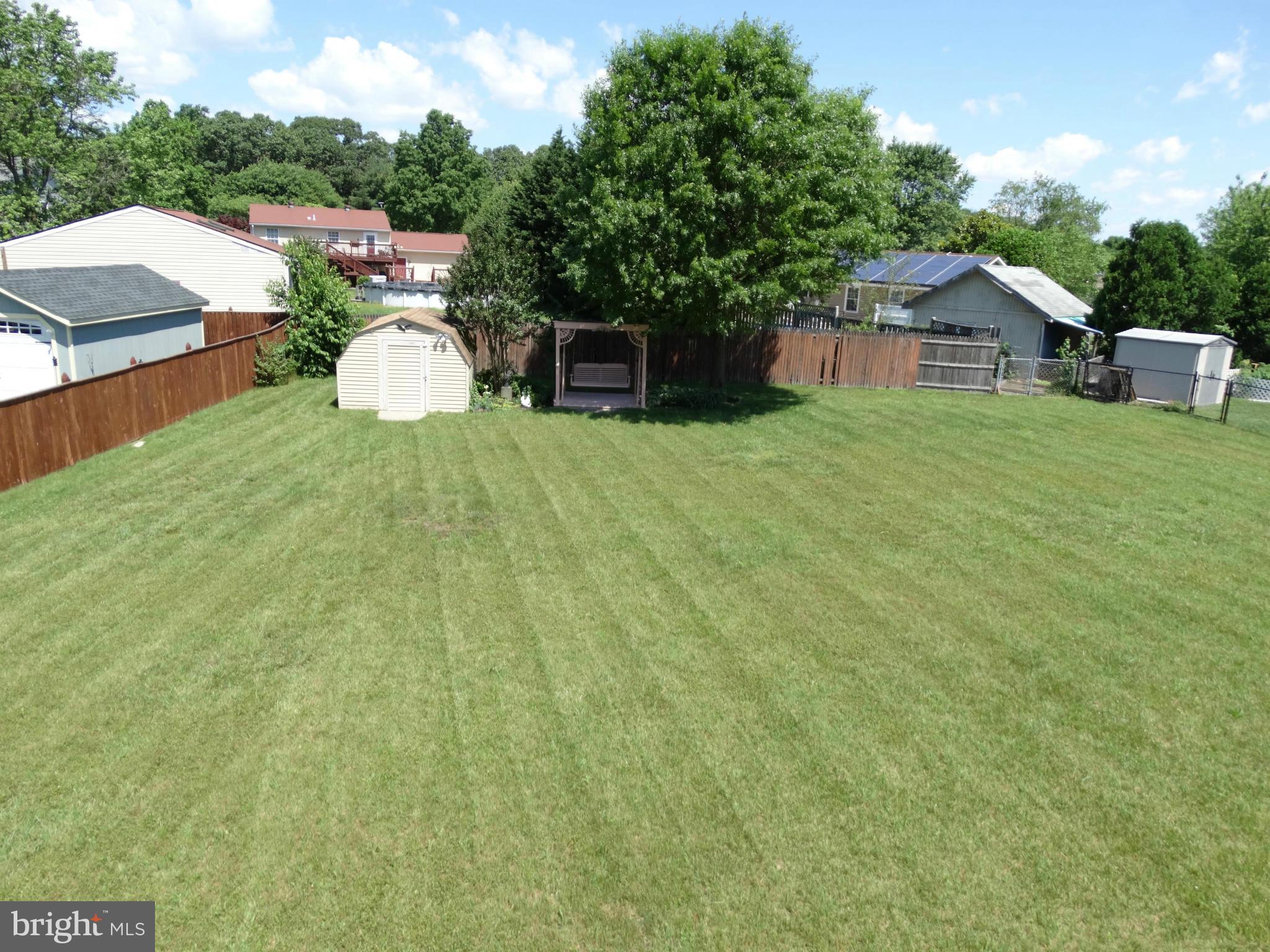 8204 Grainfield Road Severn, MD 21144 - Photo 26 of 30 a view of a house with a backyard and a patio