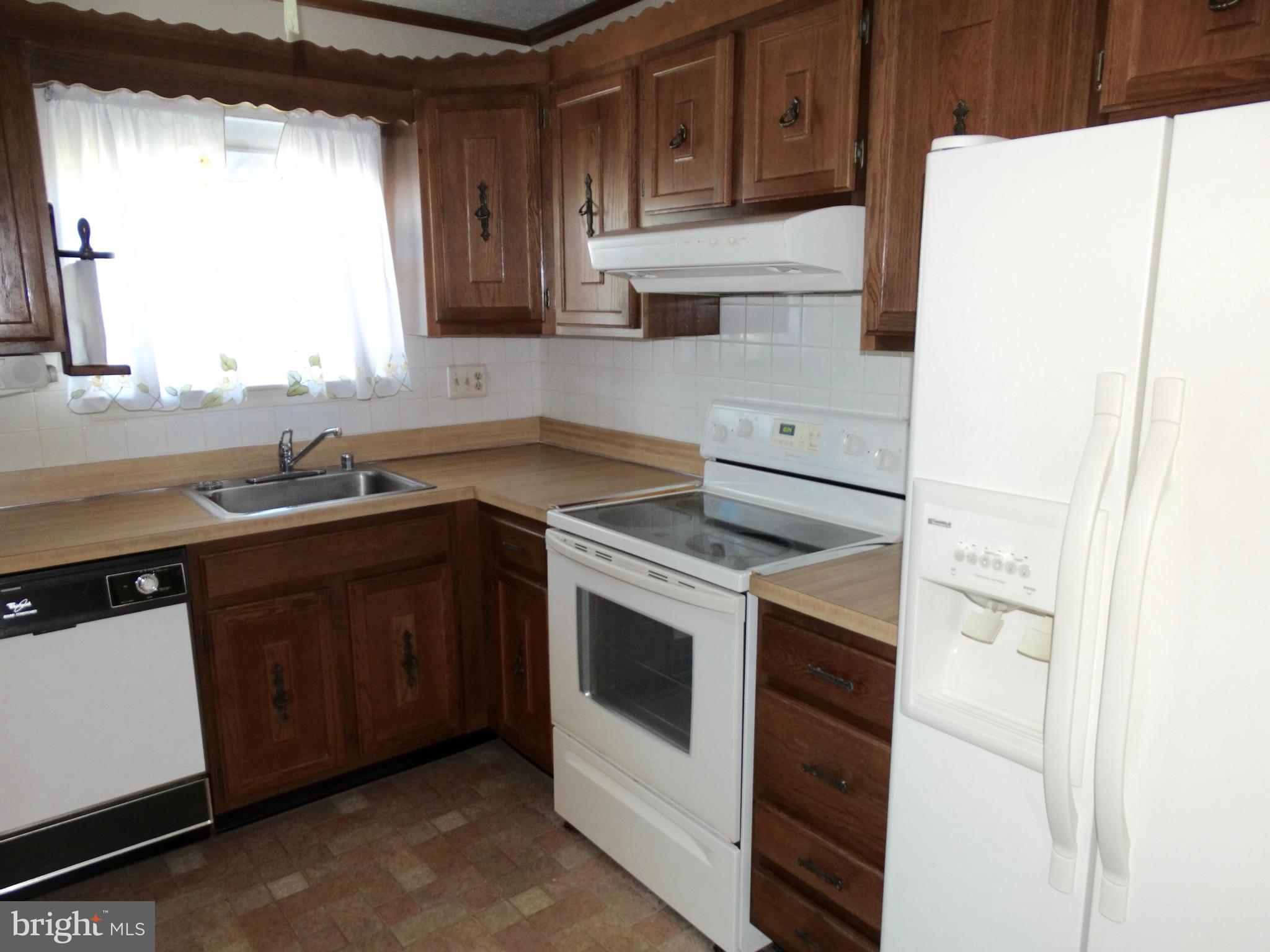 8204 Grainfield Road Severn, MD 21144 - Photo 6 of 30 a kitchen with stainless steel appliances granite countertop a sink stove and refrigerator