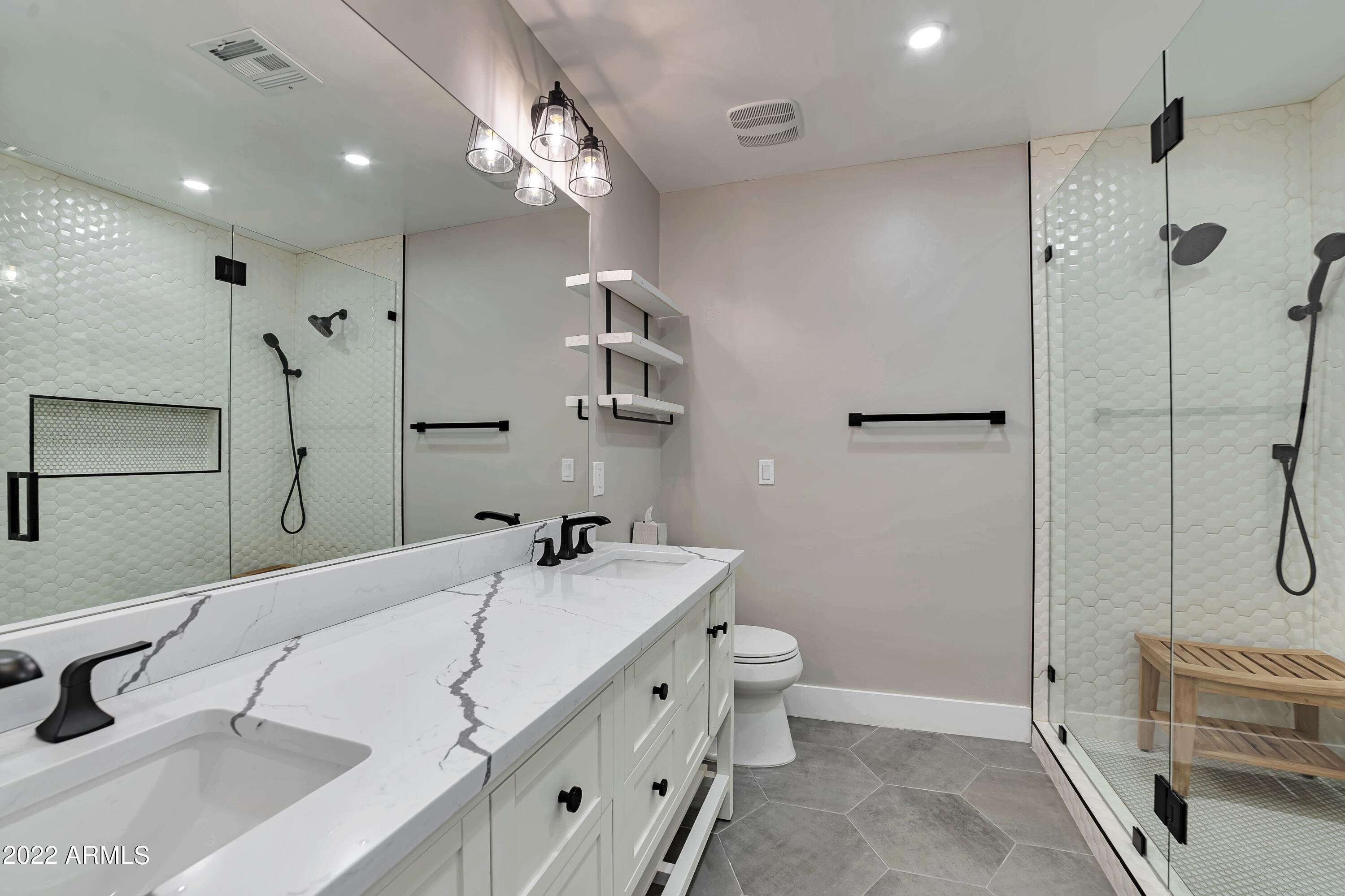 1641 West Evans Drive Phoenix, AZ 85023 - Photo 12 of 52 a spacious bathroom with a double vanity sink a toilet a mirror and shower