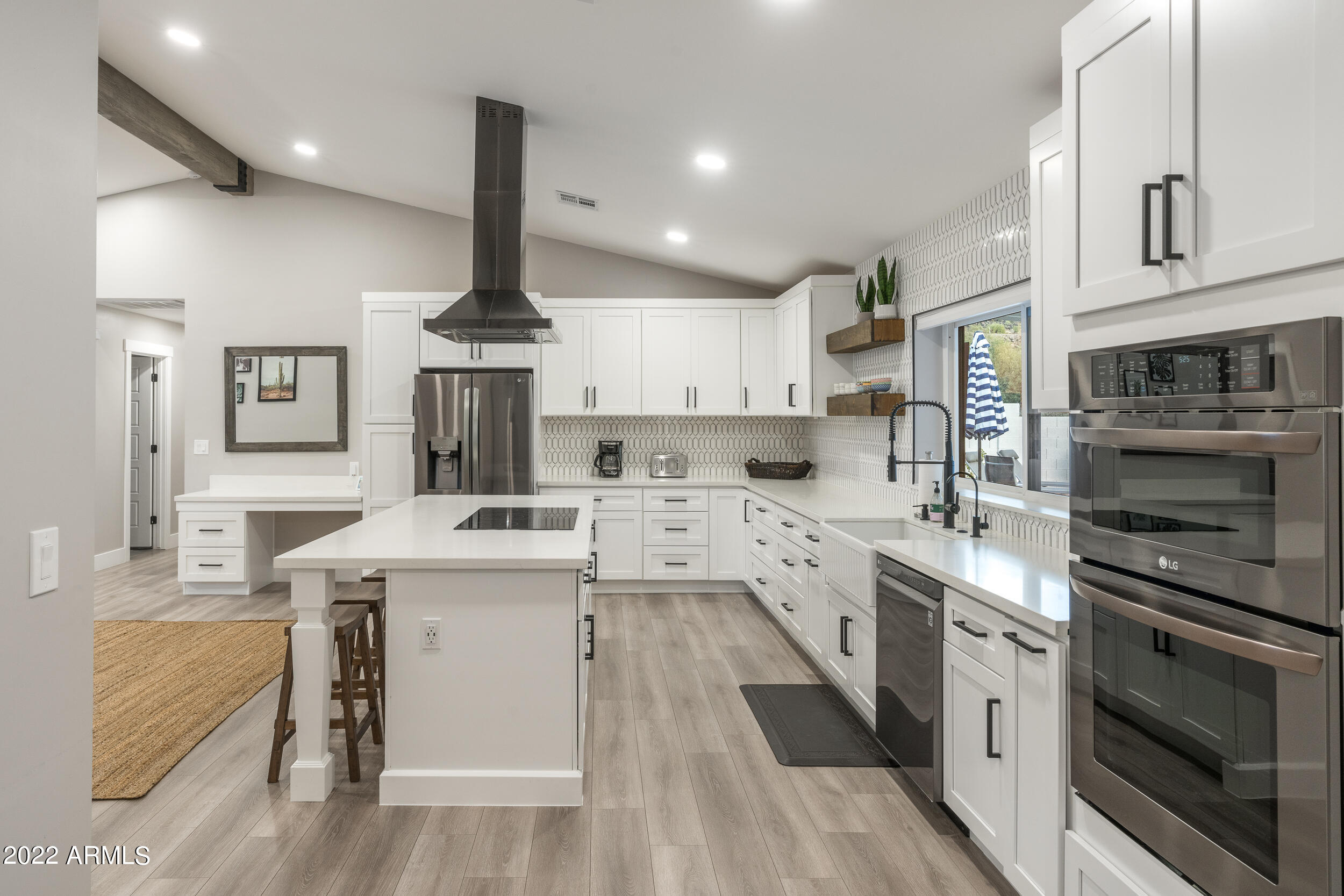 1641 West Evans Drive Phoenix, AZ 85023 - Photo 19 of 52 a kitchen with stainless steel appliances a stove sink and cabinets