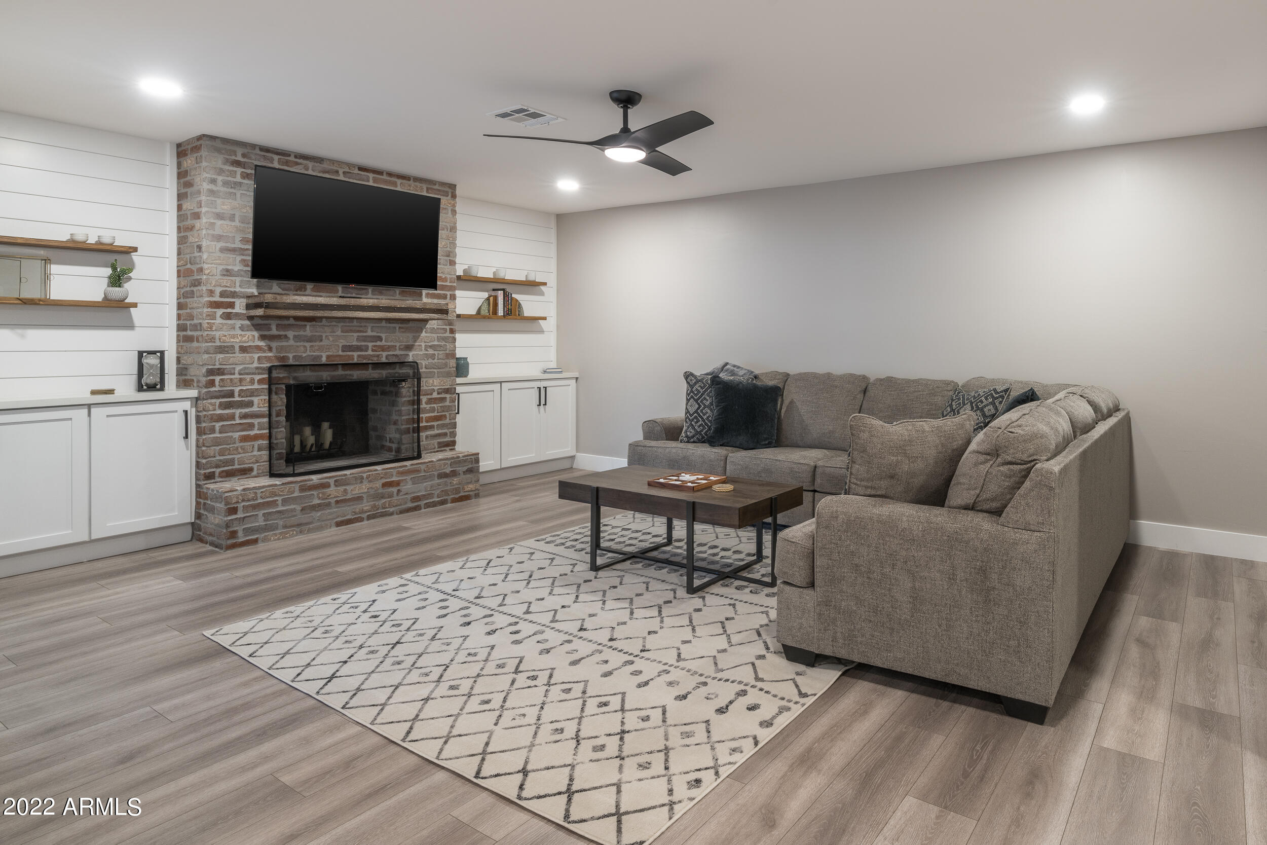 1641 West Evans Drive Phoenix, AZ 85023 - Photo 23 of 52 a living room with furniture a flat screen tv and a fireplace