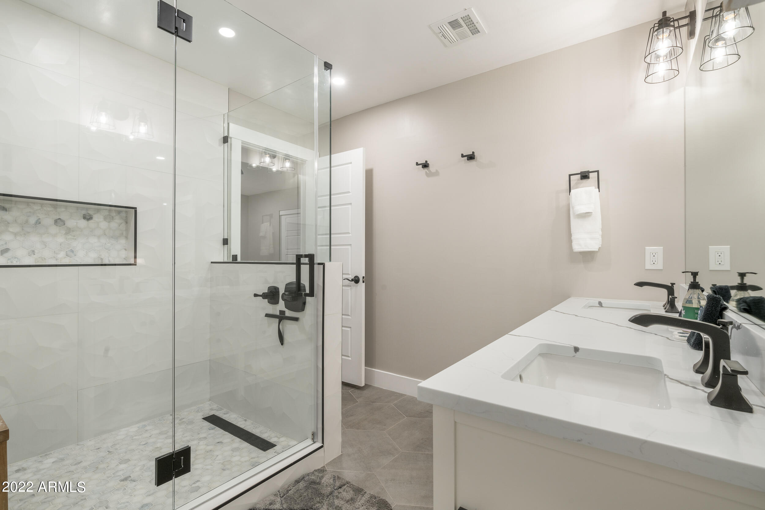 1641 West Evans Drive Phoenix, AZ 85023 - Photo 31 of 52 a bathroom with a sink a shower and a mirror