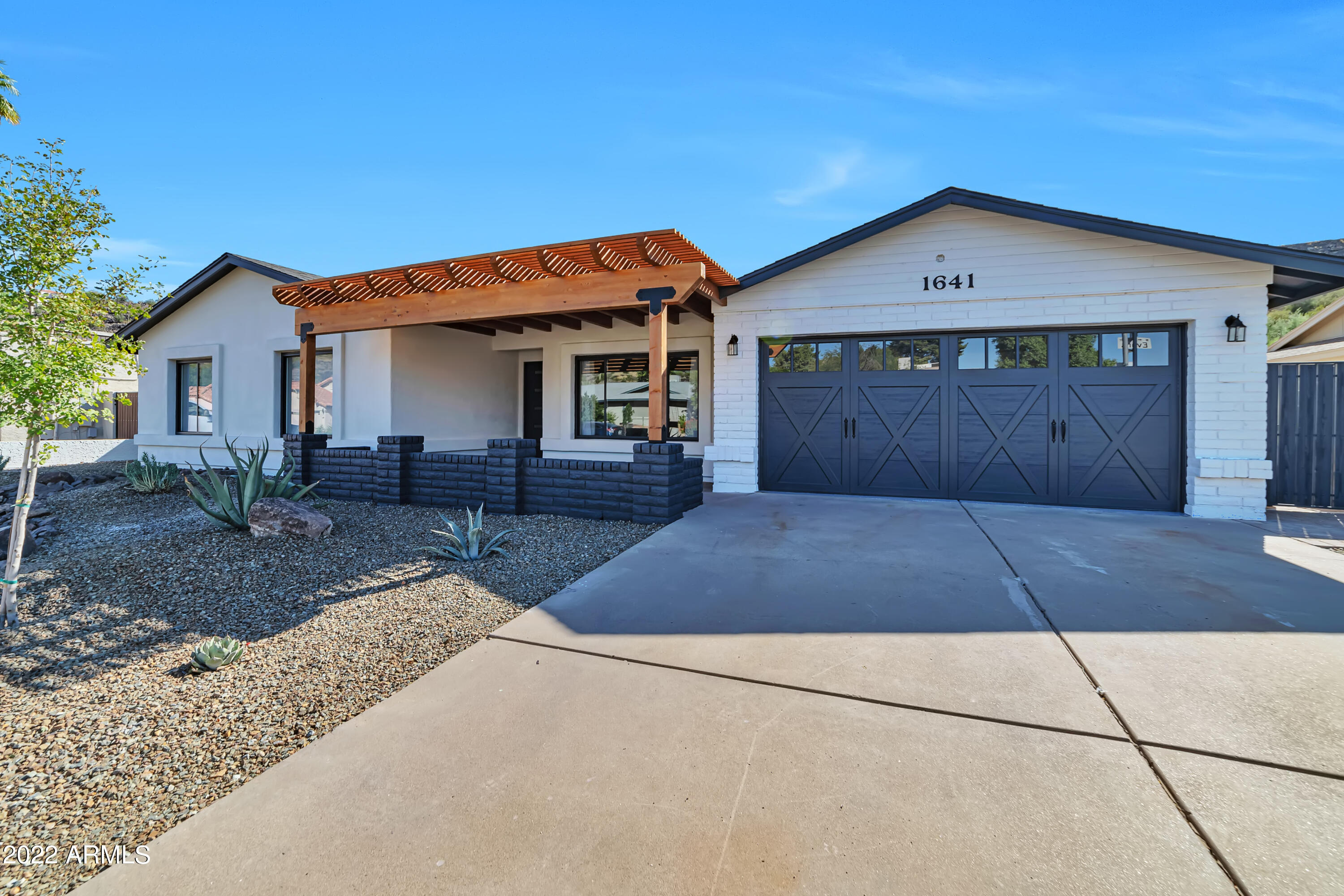 1641 West Evans Drive Phoenix, AZ 85023 - Photo 48 of 52 a front view of a house with a yard and garage