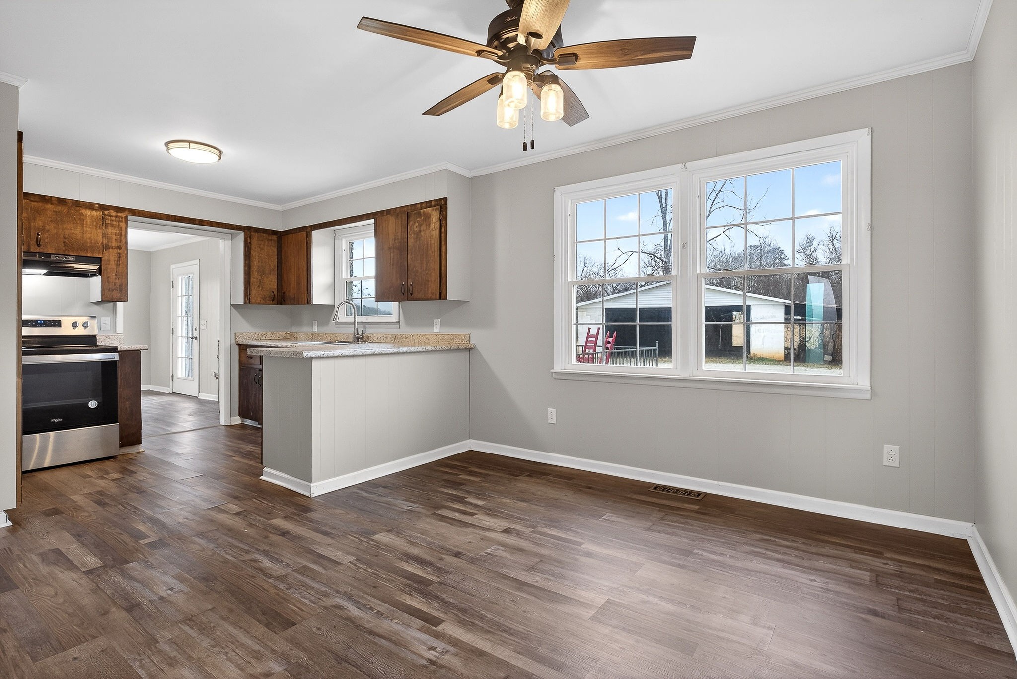 1528 Dry Creek Road McMinnville, TN 37110 - Photo 17 of 45 a view of a kitchen with a stove cabinets a ceiling fan and wooden floor