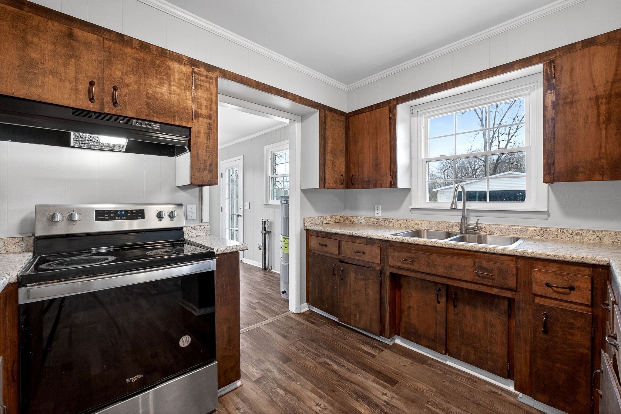 1528 Dry Creek Road McMinnville, TN 37110 - Photo 18 of 45 a kitchen with granite countertop a stove a sink and wooden cabinets