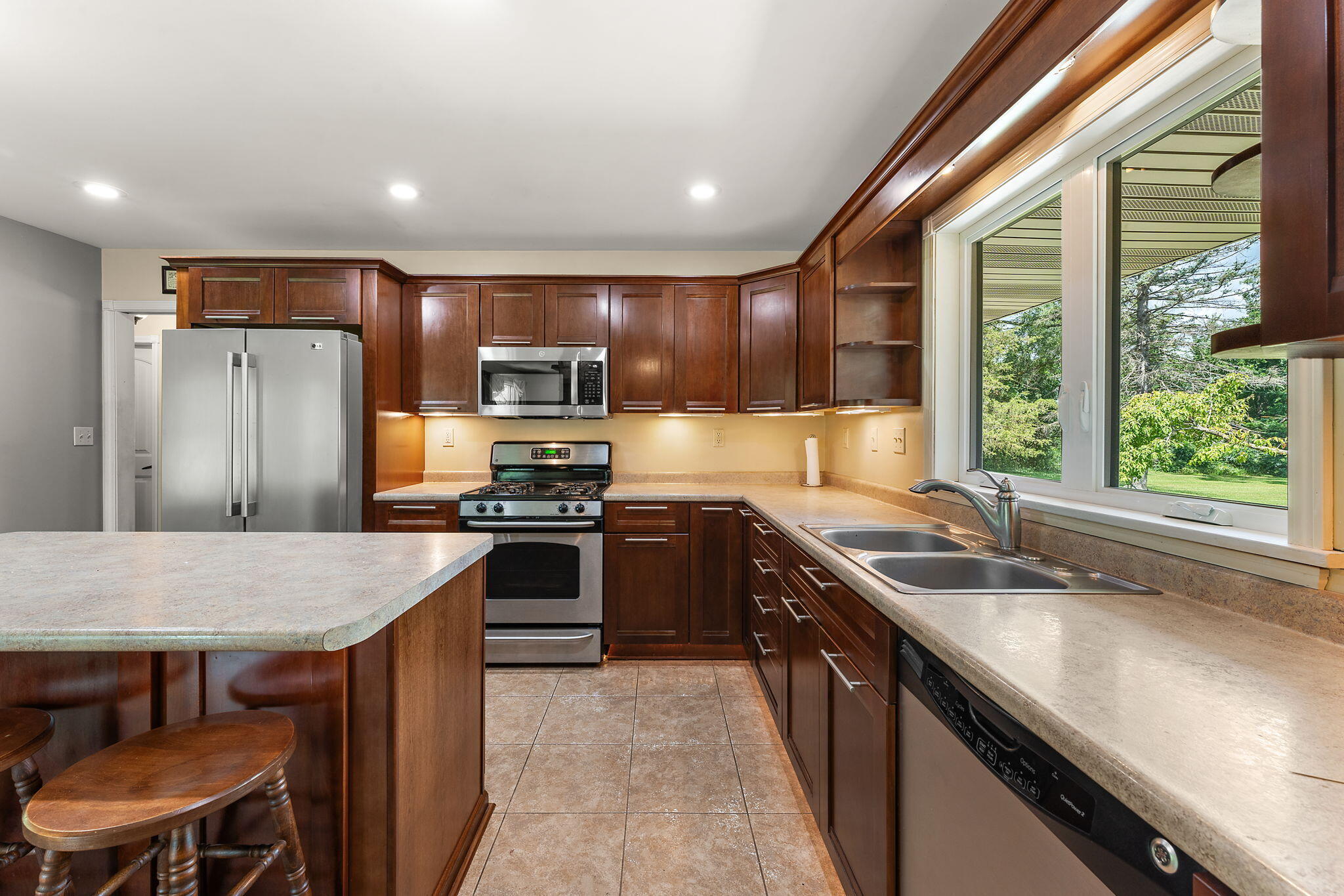 16280 Hendricks Street Lowell, IN 46356 - Photo 12 of 35 a kitchen with stainless steel appliances granite countertop a sink stove refrigerator and a large window