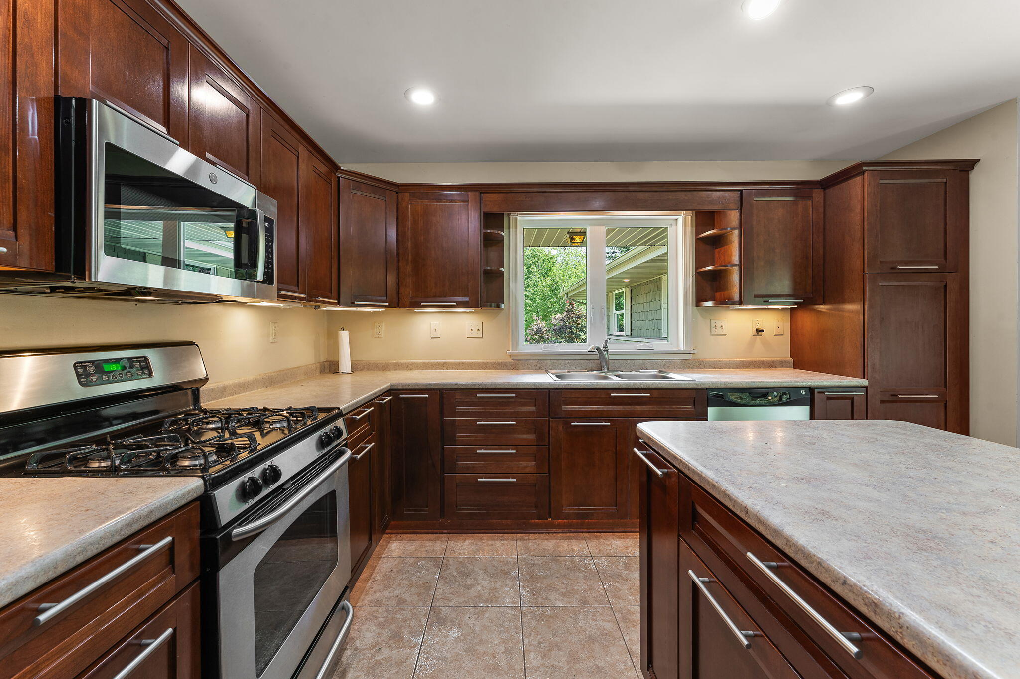 16280 Hendricks Street Lowell, IN 46356 - Photo 13 of 35 a kitchen with a stove a sink and a microwave