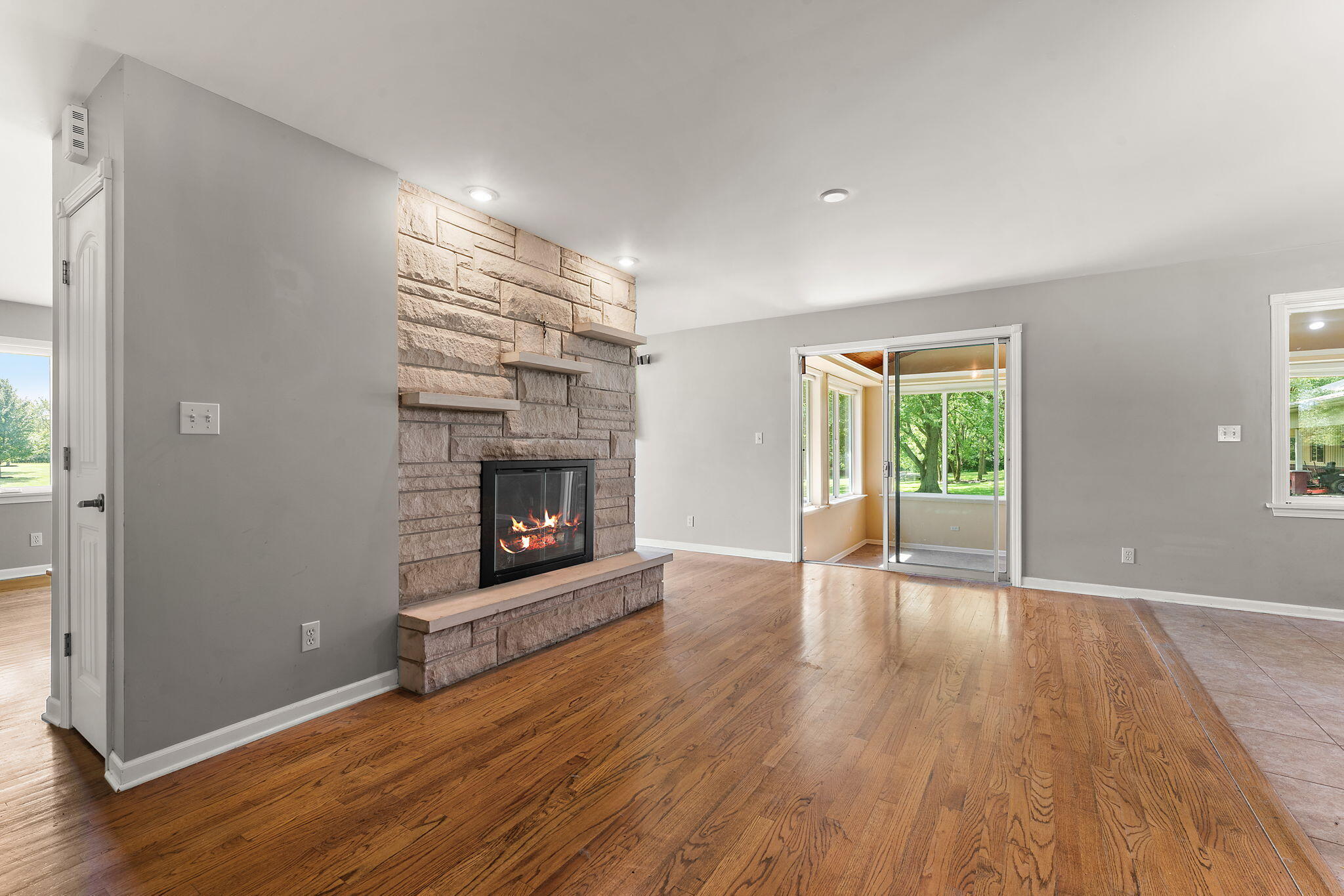 16280 Hendricks Street Lowell, IN 46356 - Photo 14 of 35 a view of an empty room with wooden floor fireplace and a window