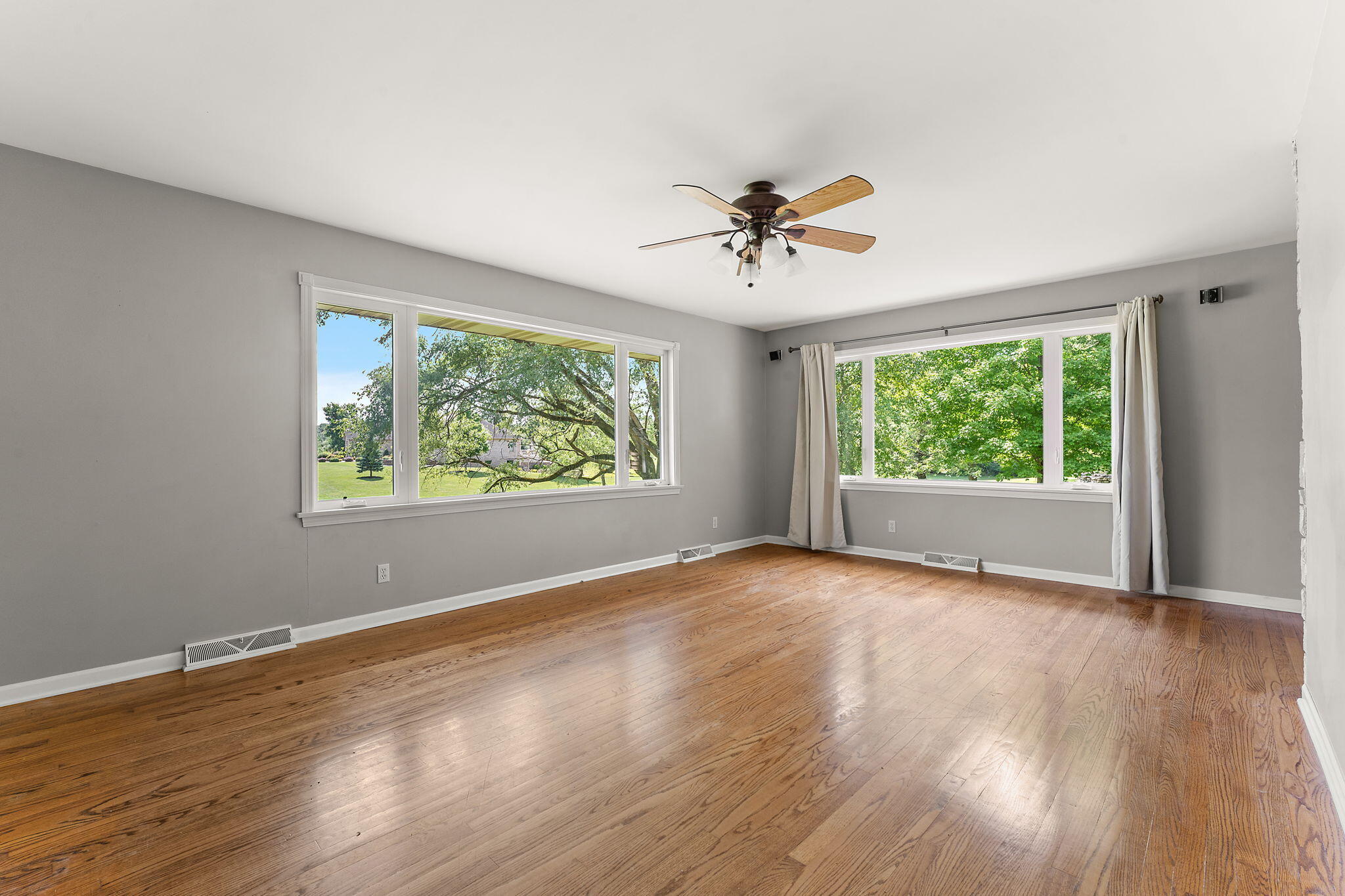 16280 Hendricks Street Lowell, IN 46356 - Photo 20 of 35 a view of an empty room with wooden floor and a window
