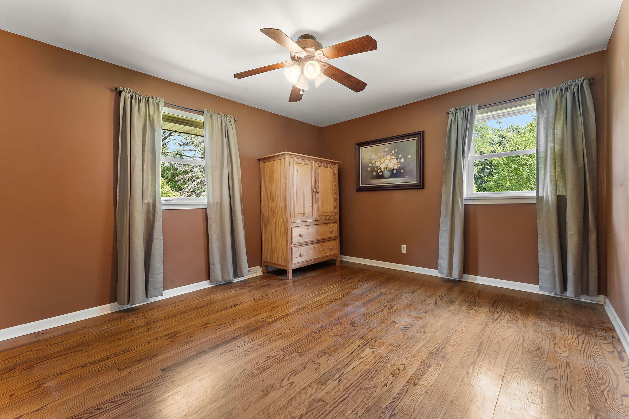 16280 Hendricks Street Lowell, IN 46356 - Photo 21 of 35 a view of an empty room with a window and a chandelier fan
