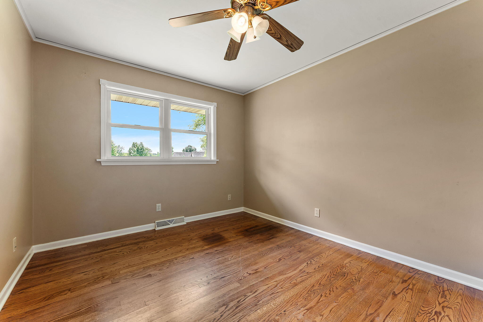 16280 Hendricks Street Lowell, IN 46356 - Photo 24 of 35 a view of empty room with wooden floor and fan