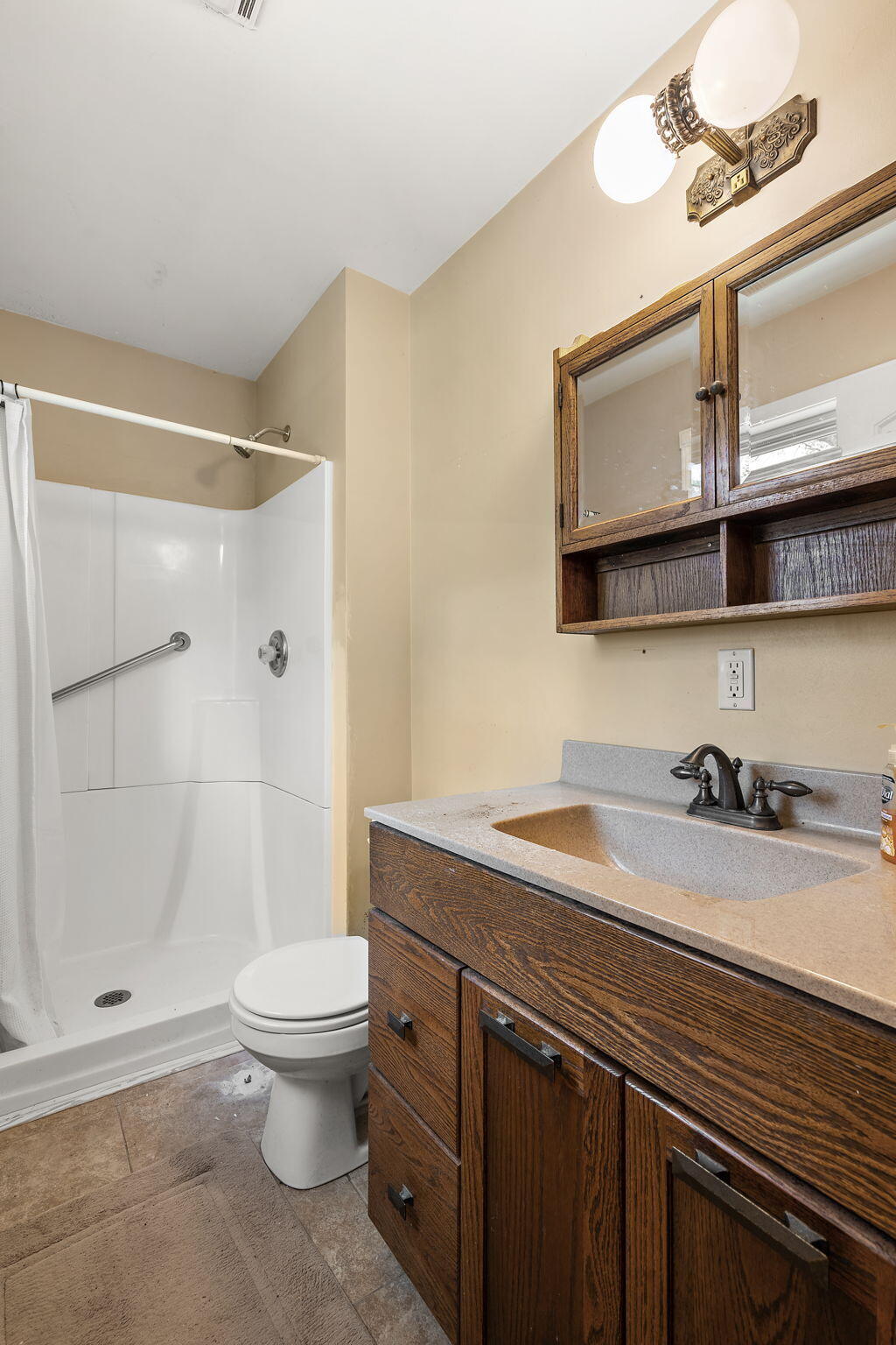 16280 Hendricks Street Lowell, IN 46356 - Photo 25 of 35 a bathroom with a granite countertop sink a toilet a mirror and shower