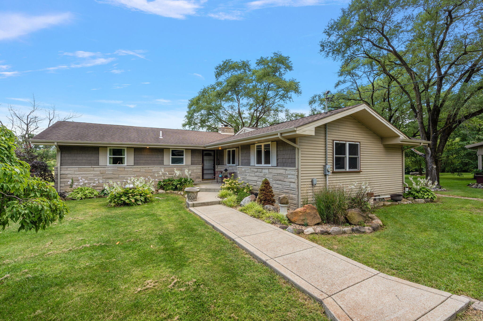 16280 Hendricks Street Lowell, IN 46356 - Photo 8 of 35 a front view of house with a garden and patio
