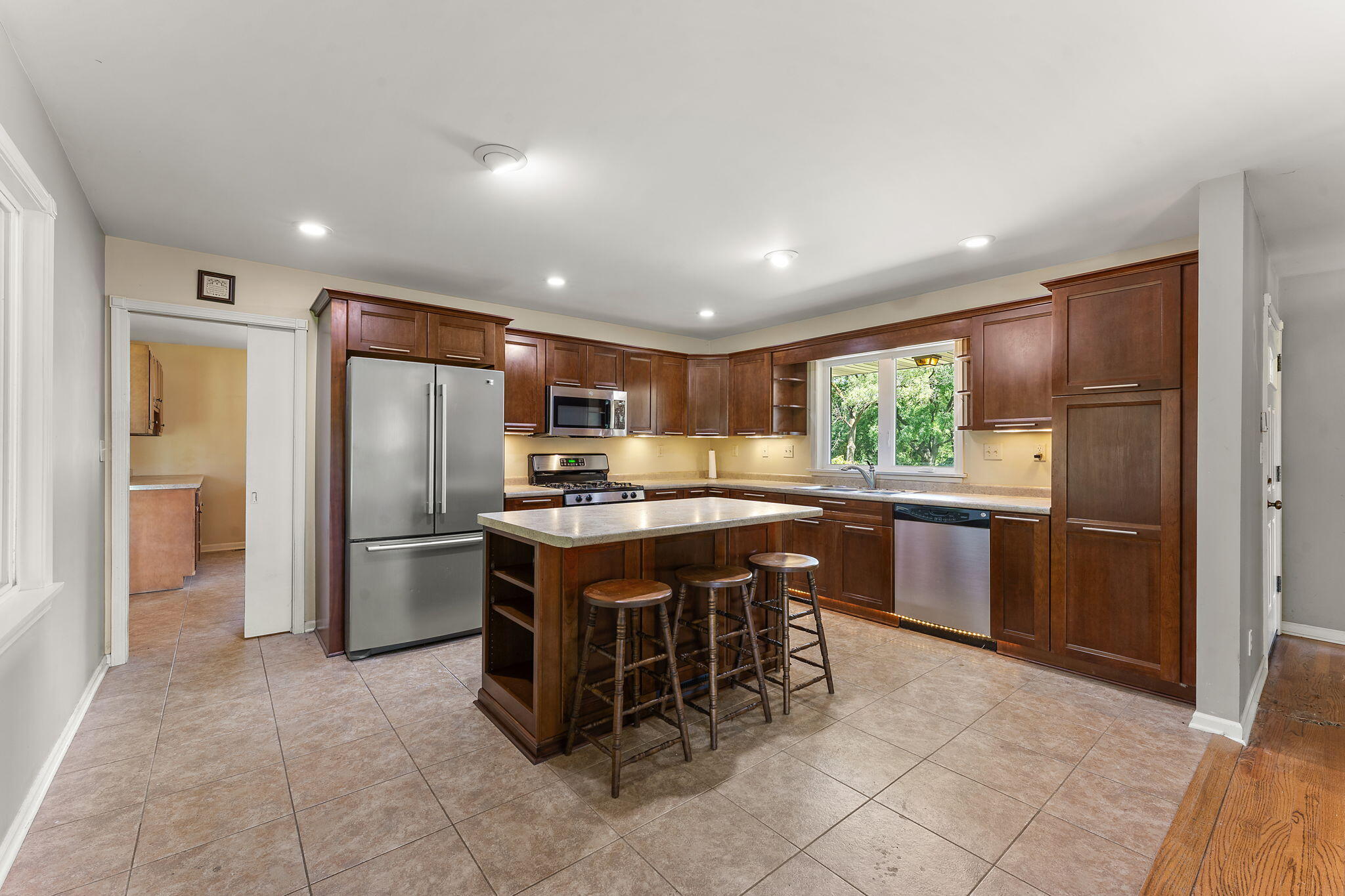 16280 Hendricks Street Lowell, IN 46356 - Photo 10 of 35 a kitchen with a refrigerator a counter top space and stainless steel appliances