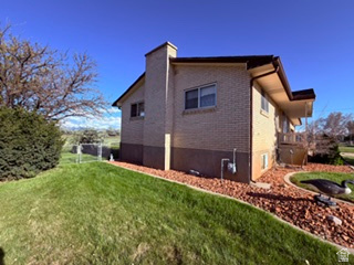 588 North 4500 West West Point, UT 84015 - Photo 51 of 61 Brick exterior with dark brown trim and a chimney feature