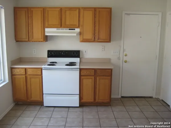 a kitchen with a stove and a cabinets