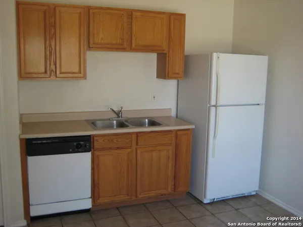 a kitchen with a sink and a refrigerator