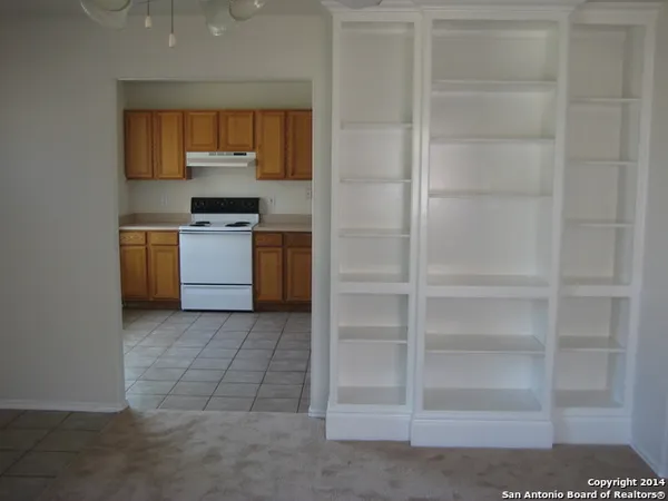 a kitchen with a refrigerator and a stove