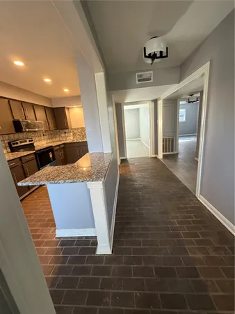 a view of kitchen with granite countertop window and a counter top space