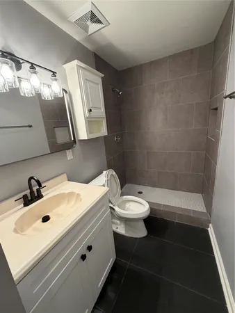a bathroom with a sink toilet and shower