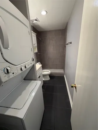 a bathroom with a toilet and a mirror